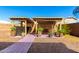 Backyard featuring dual pergolas for outdoor entertaining and potted plants at 8626 W Las Palmaritas Dr, Peoria, AZ 85345