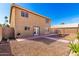 Exterior backyard view featuring a barbecue, fire pit, and double doors to the home at 8626 W Las Palmaritas Dr, Peoria, AZ 85345