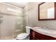 Bathroom featuring glass shower with mosaic tile accents and a classic vanity at 8626 W Las Palmaritas Dr, Peoria, AZ 85345