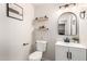 Charming powder room features floating shelves, modern vanity and decorative oval mirror at 8626 W Las Palmaritas Dr, Peoria, AZ 85345