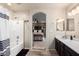 Bathroom showcasing a tub, shower, and dark wood vanity, leading to bedroom view at 8626 W Las Palmaritas Dr, Peoria, AZ 85345