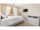 Well-lit bedroom with a large window, white bedding and a modern dresser at 8626 W Las Palmaritas Dr, Peoria, AZ 85345