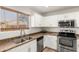 Updated kitchen featuring stainless steel appliances, white cabinets, and ample natural light at 8626 W Las Palmaritas Dr, Peoria, AZ 85345