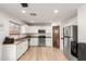 Well-lit kitchen features stainless steel appliances, white cabinets, and a charming barn door detail at 8626 W Las Palmaritas Dr, Peoria, AZ 85345