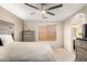 A spacious main bedroom features a ceiling fan, ensuite bathroom, and a neutral color palette at 8626 W Las Palmaritas Dr, Peoria, AZ 85345