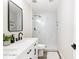 Modern bathroom with a double sink vanity, glass shower, and stylish marble tiling at 8637 E Mulberry St, Scottsdale, AZ 85251