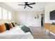 Bright bedroom with a ceiling fan, closet, and hardwood floors at 8637 E Mulberry St, Scottsdale, AZ 85251