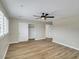 Bedroom with hardwood floors, a ceiling fan, a large window, and closet, creating a bright, airy atmosphere at 8637 E Mulberry St, Scottsdale, AZ 85251