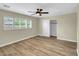 Bright bedroom featuring light hardwood floors, a ceiling fan, and a closet for storage at 8637 E Mulberry St, Scottsdale, AZ 85251