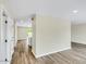 Hallway leading to a well-lit bathroom and other rooms, featuring new flooring at 8637 E Mulberry St, Scottsdale, AZ 85251