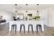 Modern kitchen featuring a large kitchen island with barstool seating and pendant lights at 8637 E Mulberry St, Scottsdale, AZ 85251