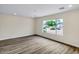 Open-concept living room with new flooring and a large window overlooking the neighborhood at 8637 E Mulberry St, Scottsdale, AZ 85251