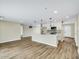 Modern living room and kitchen with an open layout, new flooring, and white cabinets at 8637 E Mulberry St, Scottsdale, AZ 85251