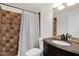 Bathroom featuring brown tile in shower, toilet, dark vanity, and mosaic mirror accents at 901 E Hearn Rd, Phoenix, AZ 85022