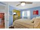 Cozy bedroom featuring a ceiling fan, large window, and closet at 901 E Hearn Rd, Phoenix, AZ 85022