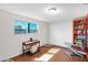 Bright bedroom with natural light, hardwood floors, closet, and a custom-built orange bookcase at 901 E Hearn Rd, Phoenix, AZ 85022