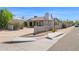 Exterior view of the home with a basketball hoop, desert landscaping, and a driveway at 901 E Hearn Rd, Phoenix, AZ 85022