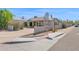 Exterior view of the home with a basketball hoop, desert landscaping, and a driveway at 901 E Hearn Rd, Phoenix, AZ 85022