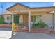 Inviting front porch with brick flooring, a comfortable seating area, and well-maintained landscaping at 901 E Hearn Rd, Phoenix, AZ 85022