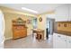 Spacious kitchen featuring a wooden hutch, bright tile floors, and an adjacent seating area at 901 E Hearn Rd, Phoenix, AZ 85022