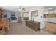 Open-concept living space with a brick fireplace, tile floors, and seamless flow into the kitchen and dining areas at 901 E Hearn Rd, Phoenix, AZ 85022