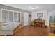 Cozy living room with brick walls, natural light, and hardwood floors creating a warm and inviting atmosphere at 901 E Hearn Rd, Phoenix, AZ 85022