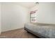 Bedroom featuring tiled floor, window, and neutral color scheme at 9325 W Elwood St, Tolleson, AZ 85353