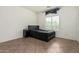 Bedroom with tile floors, black platform bed and tufted headboard at 9325 W Elwood St, Tolleson, AZ 85353