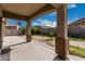 Covered patio overlooking backyard with block fence and desert landscaping at 9325 W Elwood St, Tolleson, AZ 85353