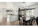 Bright dining area featuring a wooden dining table, hutch, and large window at 9325 W Elwood St, Tolleson, AZ 85353