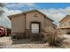 Side of a tan home, featuring a window and a well-kept yard at 9325 W Elwood St, Tolleson, AZ 85353