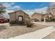 Tan home featuring a window, a red truck in the driveway, and a well-kept yard at 9325 W Elwood St, Tolleson, AZ 85353