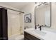 Bathroom featuring a vessel sink on a wood vanity, decorative lights, shower, and tub at 977 E Saratoga St, Gilbert, AZ 85296