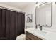 Bathroom featuring a vessel sink on a wood vanity with decorative lights and a shower curtain at 977 E Saratoga St, Gilbert, AZ 85296