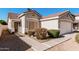 The exterior of this home features a red tile roof, manicured landscaping, and a front entrance walkway at 977 E Saratoga St, Gilbert, AZ 85296