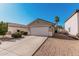 Exterior of home with a two-car garage, low maintenance landscaping, and a red tiled roof at 977 E Saratoga St, Gilbert, AZ 85296