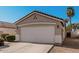 View of a single-Gathering home's garage, featuring a tiled roof, a driveway, and low-maintenance landscaping at 977 E Saratoga St, Gilbert, AZ 85296