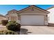 Close-up of a home's garage with a clean concrete driveway, featuring a red-tiled roof and manicured shrubs at 977 E Saratoga St, Gilbert, AZ 85296