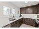 Bright kitchen with shaker cabinets, quartz countertops, modern faucet, and ample natural light at 977 E Saratoga St, Gilbert, AZ 85296