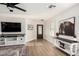 Bright living room with wood floors, ceiling fan, modern furnishings, and a decorative horse artwork at 977 E Saratoga St, Gilbert, AZ 85296