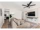 Inviting living room features modern decor, a ceiling fan, wood-look floors and a comfortable sectional sofa at 977 E Saratoga St, Gilbert, AZ 85296