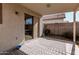 Covered patio with decorative outdoor rug and sliding glass door at 977 E Saratoga St, Gilbert, AZ 85296