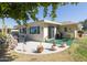 Back patio with dining area, grill, view of golf course, and desert landscaping at 10106 W Highwood Ln, Sun City, AZ 85373