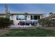 Back patio with seating area, beautiful desert landscaping, and view of golf course at 10106 W Highwood Ln, Sun City, AZ 85373