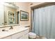 Well-lit bathroom featuring white vanity, modern fixtures, and shower with a curtain at 10106 W Highwood Ln, Sun City, AZ 85373