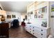 Bright bedroom featuring desk, built-in shelving, and view to the Primary bedroom at 10106 W Highwood Ln, Sun City, AZ 85373