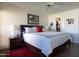 Bright bedroom with a large bed, nightstands, and view to walk-in closet at 10106 W Highwood Ln, Sun City, AZ 85373