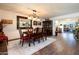 Elegant dining room with wood floors, chandelier, decorative mirror, and seating for six at 10106 W Highwood Ln, Sun City, AZ 85373