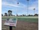 Scenic view of the Willowbrook golf course, featuring lush greens, tall palm trees, and clear blue skies at 10106 W Highwood Ln, Sun City, AZ 85373