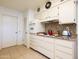 Cozy kitchen with traditional cabinets, tiled backsplash, and modern appliances at 10106 W Highwood Ln, Sun City, AZ 85373